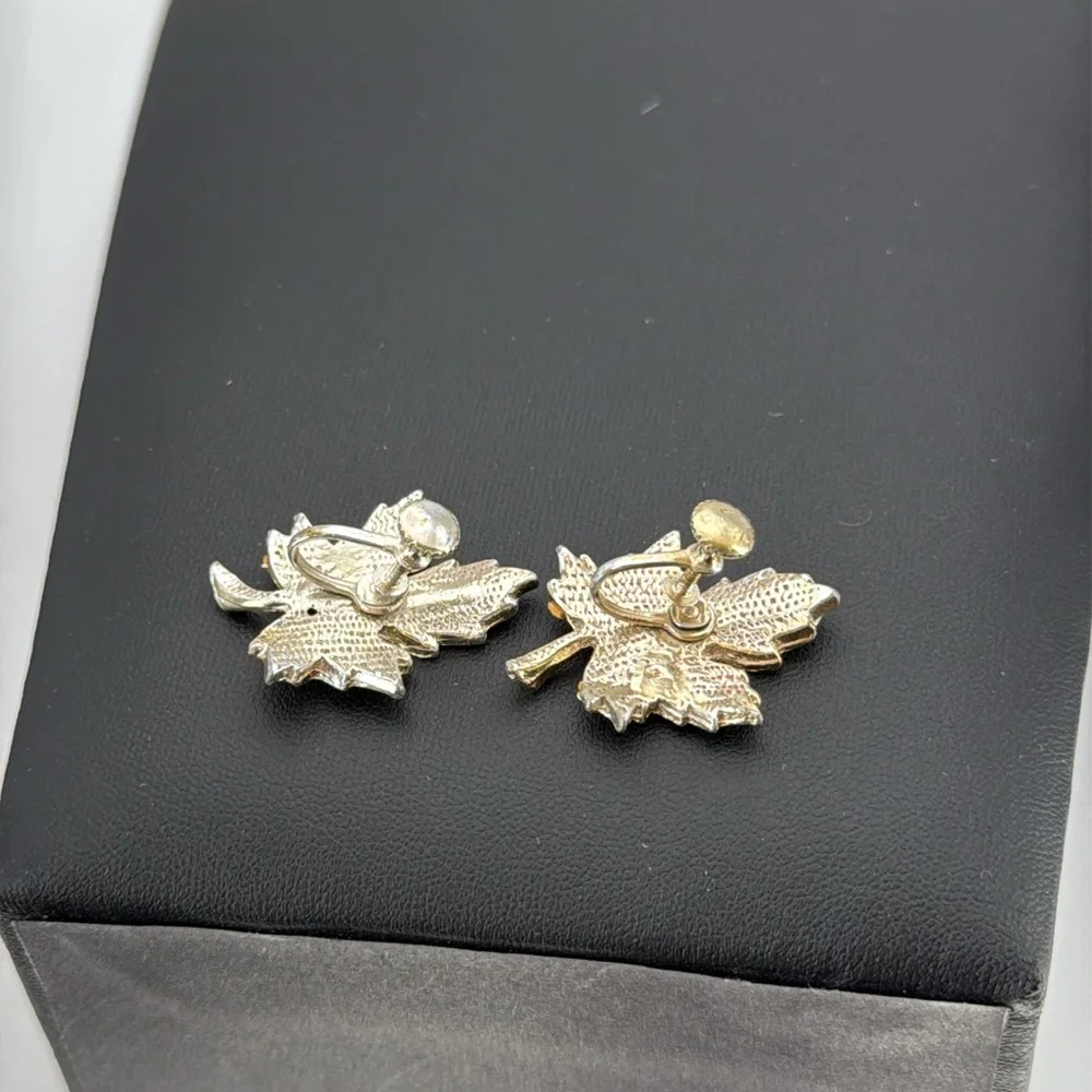 Gold tone textured leaf rhinestone accent screw back statement earrings